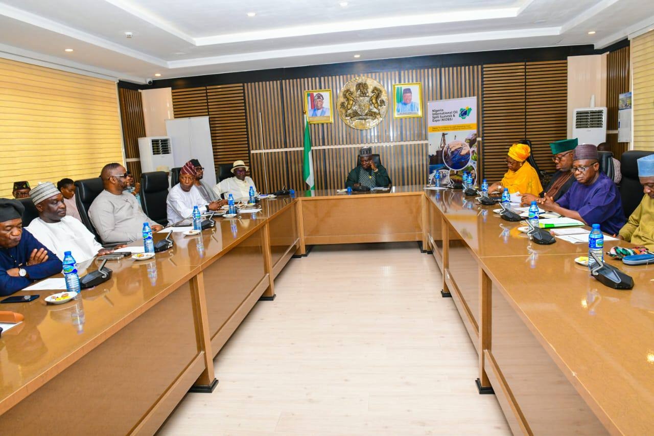 Full boardroom meeting — wide shot